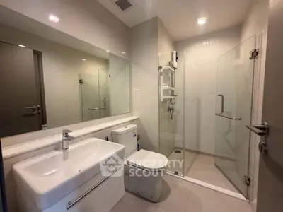 Modern bathroom with sleek fixtures and glass shower enclosure