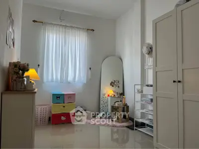 Charming bedroom with modern decor and ample storage space, featuring a cozy ambiance and stylish furnishings.