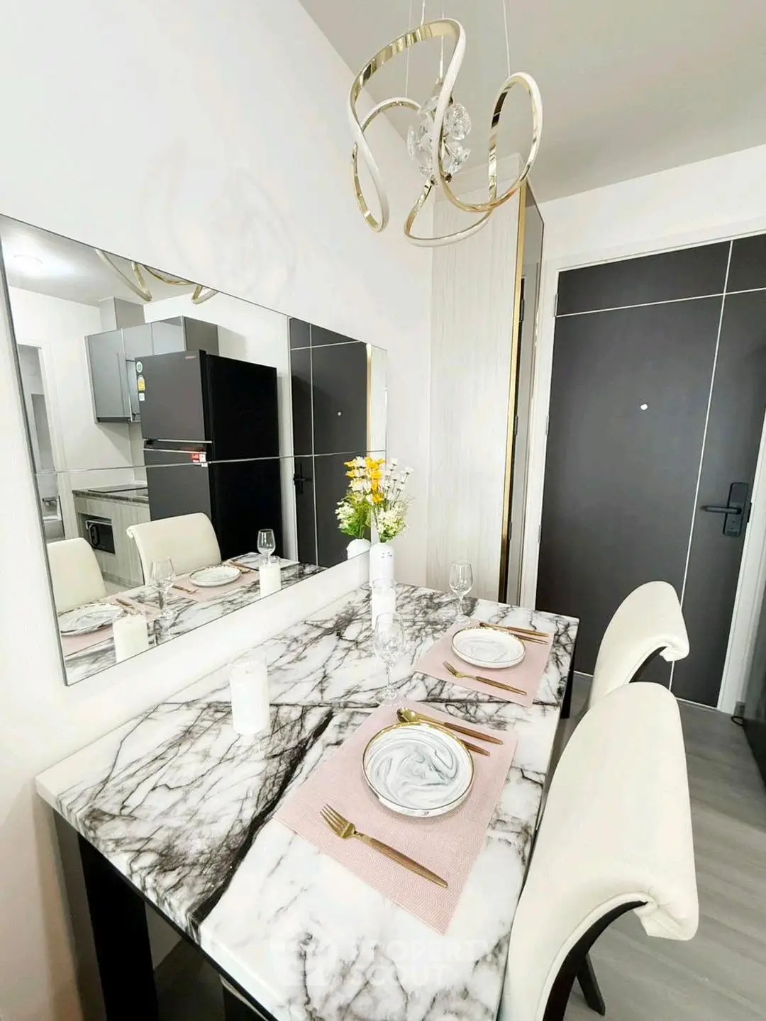 Modern dining area with marble table and elegant chandelier in stylish apartment.