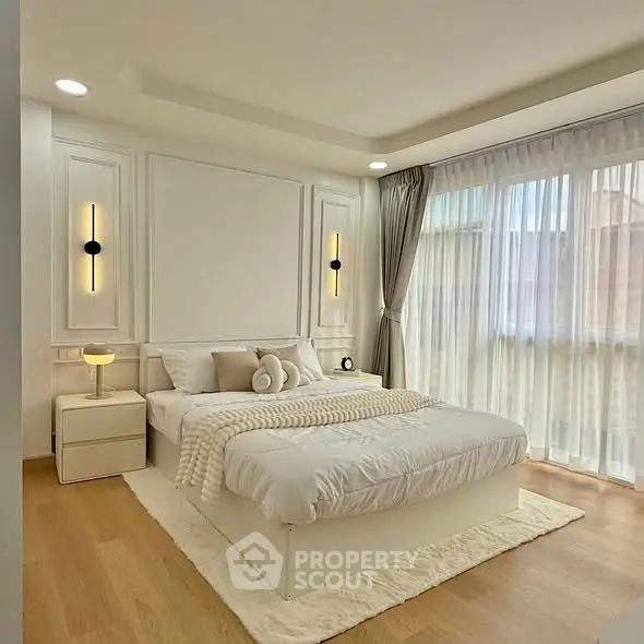 Elegant bedroom with modern decor and large windows for natural light