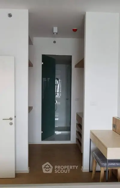 Modern minimalist interior with glass shower and wooden flooring