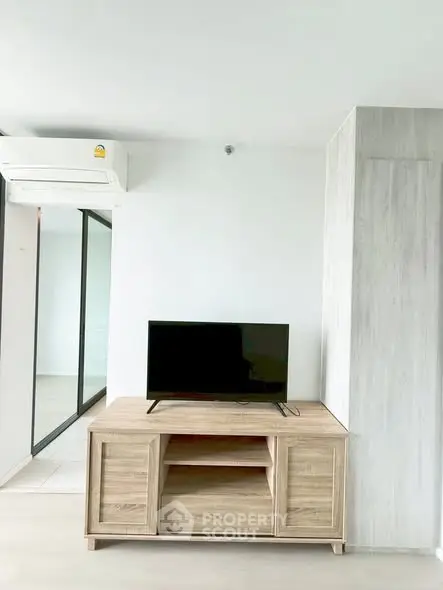Modern living room with sleek TV stand and air conditioning unit, perfect for comfortable living.