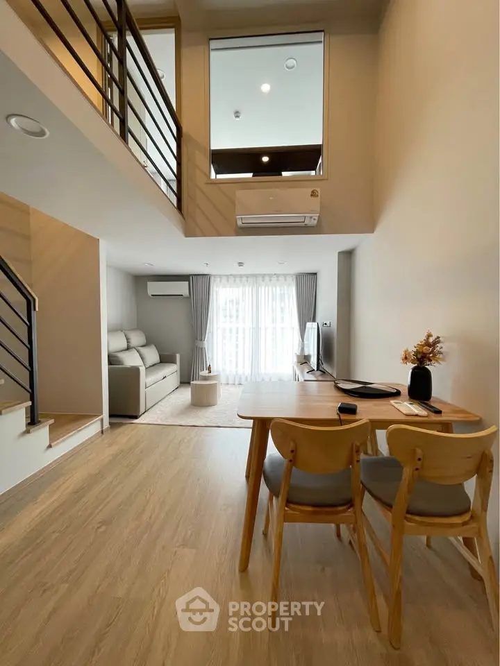Spacious modern living room with high ceiling and elegant decor