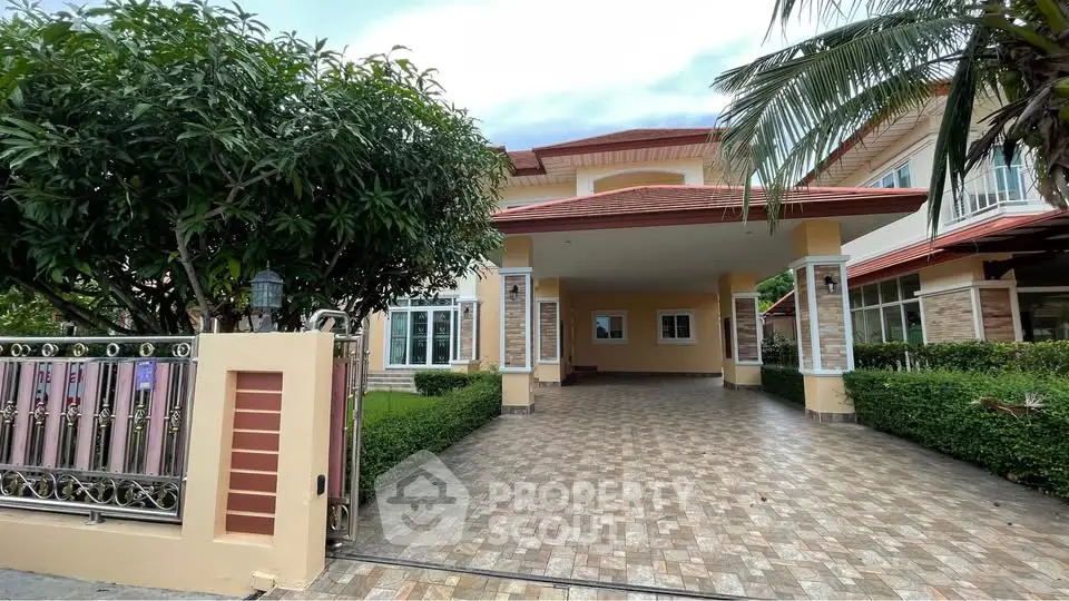 Stunning two-story home with spacious driveway and lush greenery, perfect for family living.