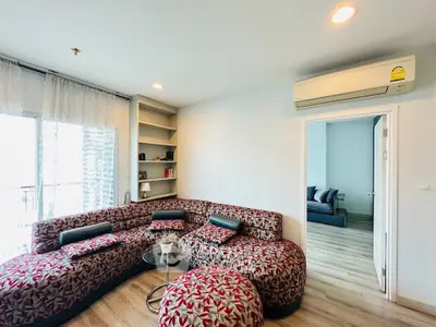 Stylish living room with modern sofa and air conditioning, perfect for relaxation.