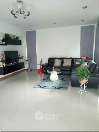 Spacious living room with modern decor and comfortable seating in a stylish home.