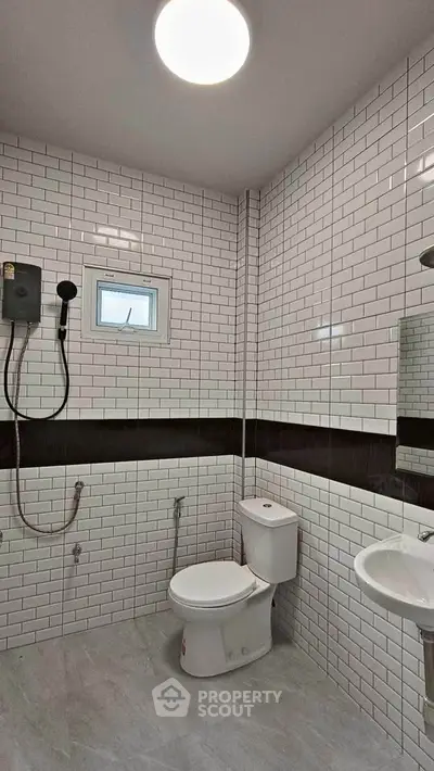 Modern bathroom with white subway tiles and sleek fixtures