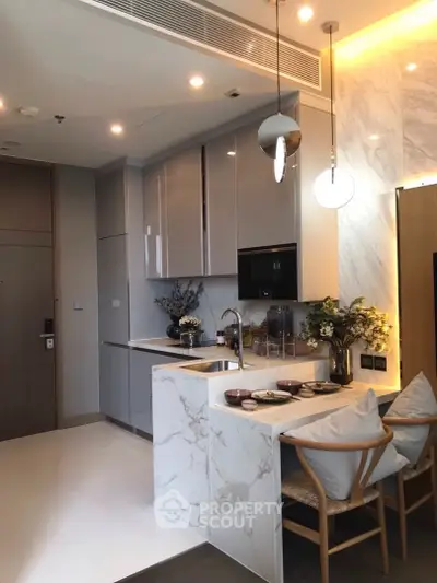 Modern kitchen with marble countertops and cozy dining area in luxury apartment