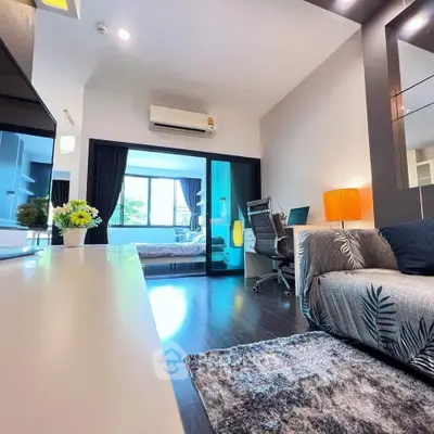 Modern living room with stylish decor and view into a cozy bedroom