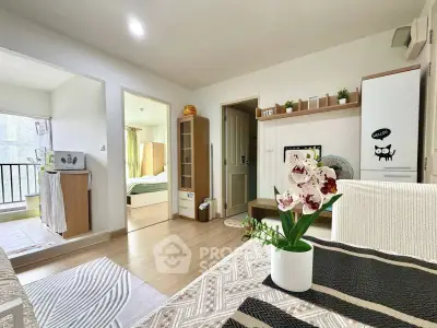 Charming open-layout living space with modern decor and natural light, featuring a cozy dining area and stylish furnishings.