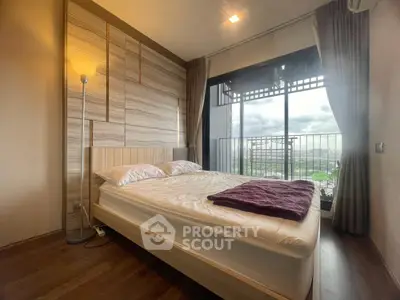 Modern bedroom with large window and scenic view, featuring stylish decor and cozy ambiance.