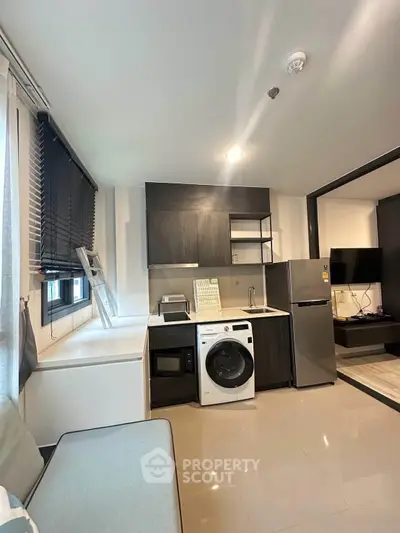 Modern kitchen with sleek appliances and open layout in stylish apartment