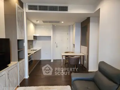 Modern apartment interior with sleek kitchen and cozy living area, featuring elegant furniture and stylish decor.