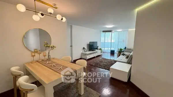 Stylish open-plan living and dining area with modern decor and ample natural light.