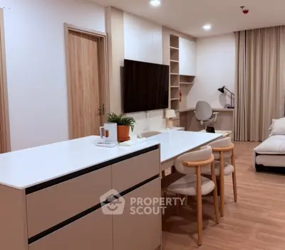 Modern living room with stylish furniture and open layout, featuring a cozy study area and elegant decor.