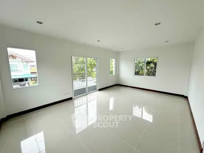 Spacious empty room with large windows and glossy tiled floor