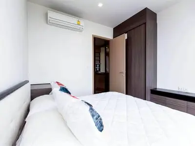 Modern bedroom with air conditioning and sleek wooden furniture, perfect for comfort and style.