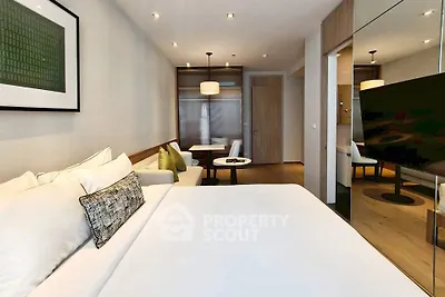 Modern bedroom with elegant decor and cozy seating area, perfect for relaxation and comfort.