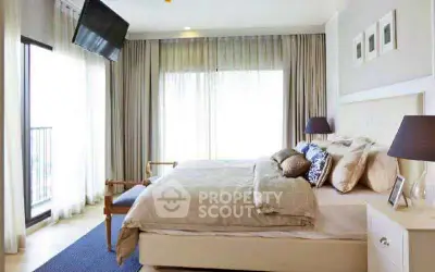 Luxurious bedroom with elegant decor and natural light, featuring a cozy bed and stylish furnishings.
