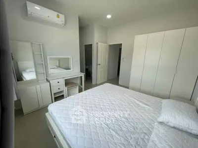 Modern bedroom with white furniture and air conditioning in a stylish apartment.