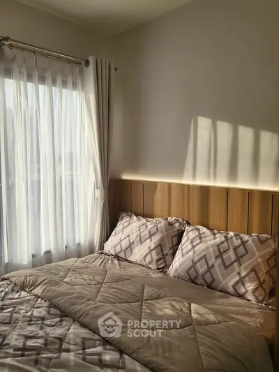 Cozy bedroom with natural light and elegant decor, perfect for relaxation.