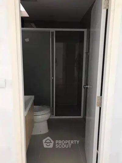 Modern bathroom with sleek shower enclosure and minimalist design.