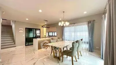 Elegant open-plan dining area with modern kitchen and stylish decor