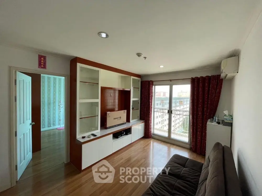 Spacious living room with modern decor and large windows for natural light