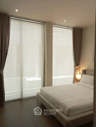 Elegant bedroom with floor-to-ceiling windows and modern decor