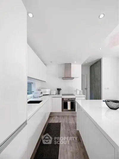 Modern white kitchen with sleek design and stainless steel appliances