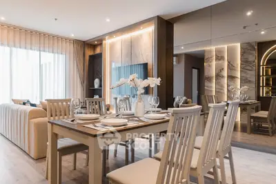 Luxurious open-plan living and dining area with elegant decor and natural light.