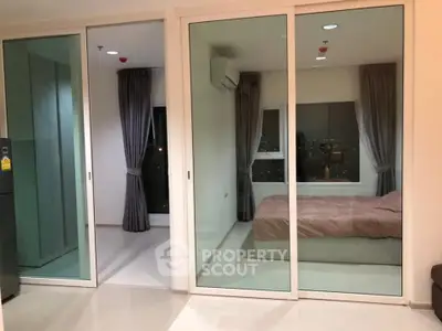 Modern apartment with glass sliding doors and cozy bedroom view.