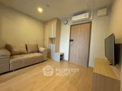 Cozy living room with modern furniture and wooden flooring in a stylish apartment.