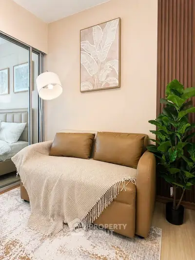 Cozy living room with leather sofa, indoor plant, and modern decor