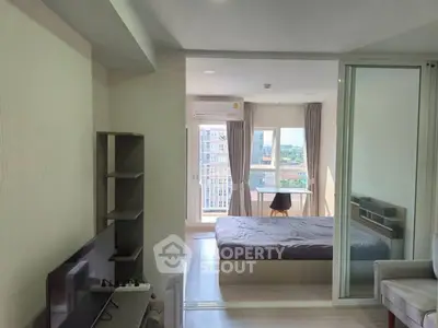 Modern apartment interior with cozy bedroom and living area, featuring large windows and natural light.