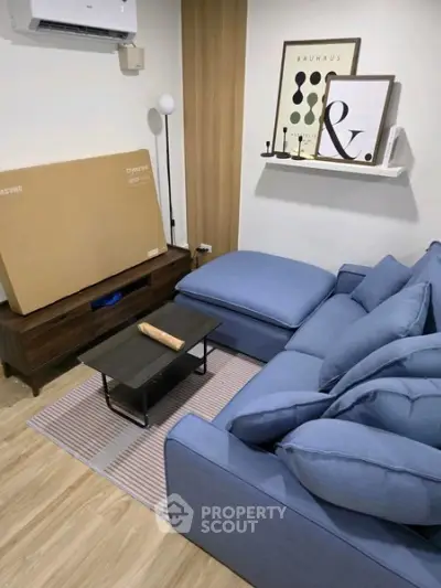 Modern living room with blue sectional sofa and stylish decor