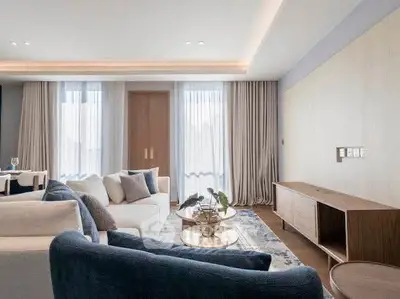 Elegant living room with modern furniture and natural light, featuring stylish decor and cozy ambiance.