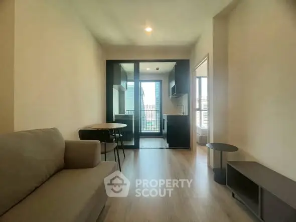 Modern living room with open kitchen and balcony view