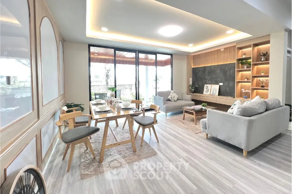 Spacious and modern living room with ample natural light, elegant furniture, and a cozy atmosphere, perfect for relaxation and entertaining guests.