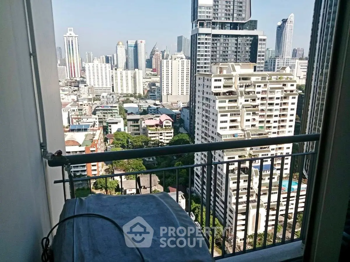 Stunning cityscape view from a high-rise balcony in a modern urban setting.