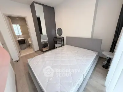 Modern bedroom with ensuite bathroom and stylish furniture in a contemporary apartment.