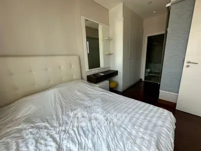Cozy bedroom with modern decor and ensuite bathroom in a stylish apartment.