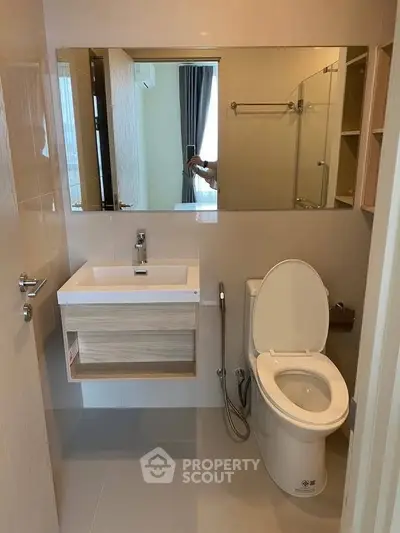 Modern bathroom with sleek fixtures and large mirror