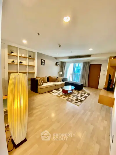 Spacious modern living room with cozy sofa and stylish decor, perfect for relaxation and entertainment.