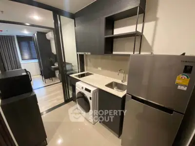 Modern kitchen with sleek appliances and compact design in a stylish apartment.