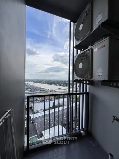 High-rise balcony with air conditioning units and panoramic city view