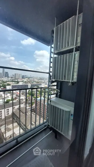 High-rise balcony with city view and air conditioning units, perfect for urban living.