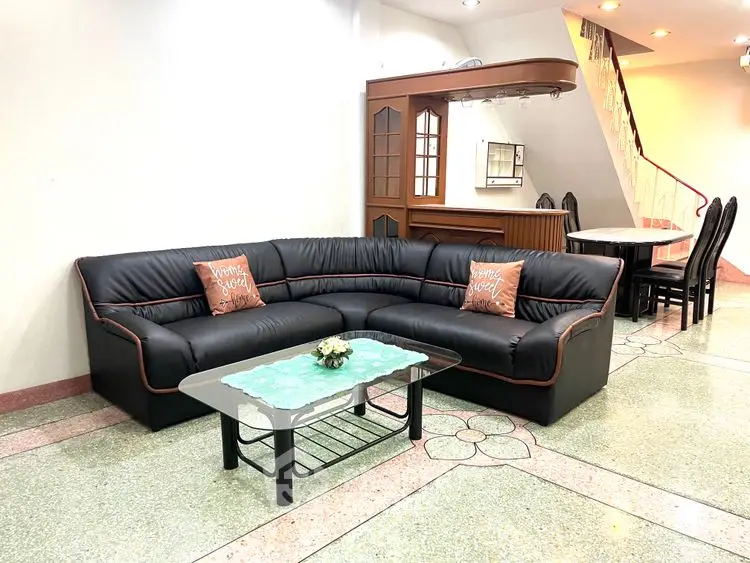 Spacious living room with modern black sectional sofa and elegant decor