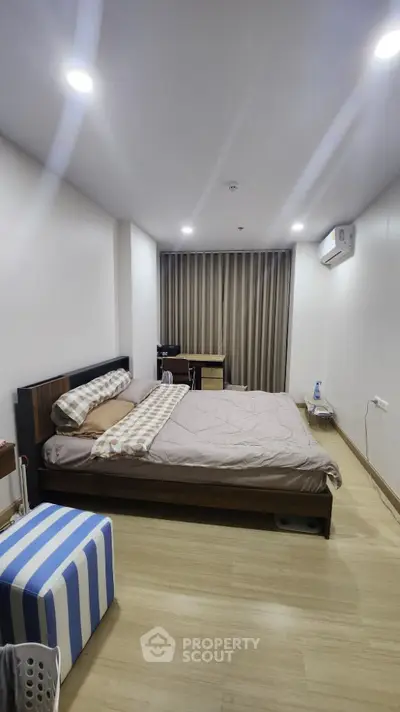 Modern bedroom with cozy bed and stylish decor in a spacious apartment
