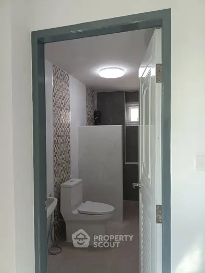 Modern bathroom with sleek design and contemporary fixtures in a stylish real estate property.